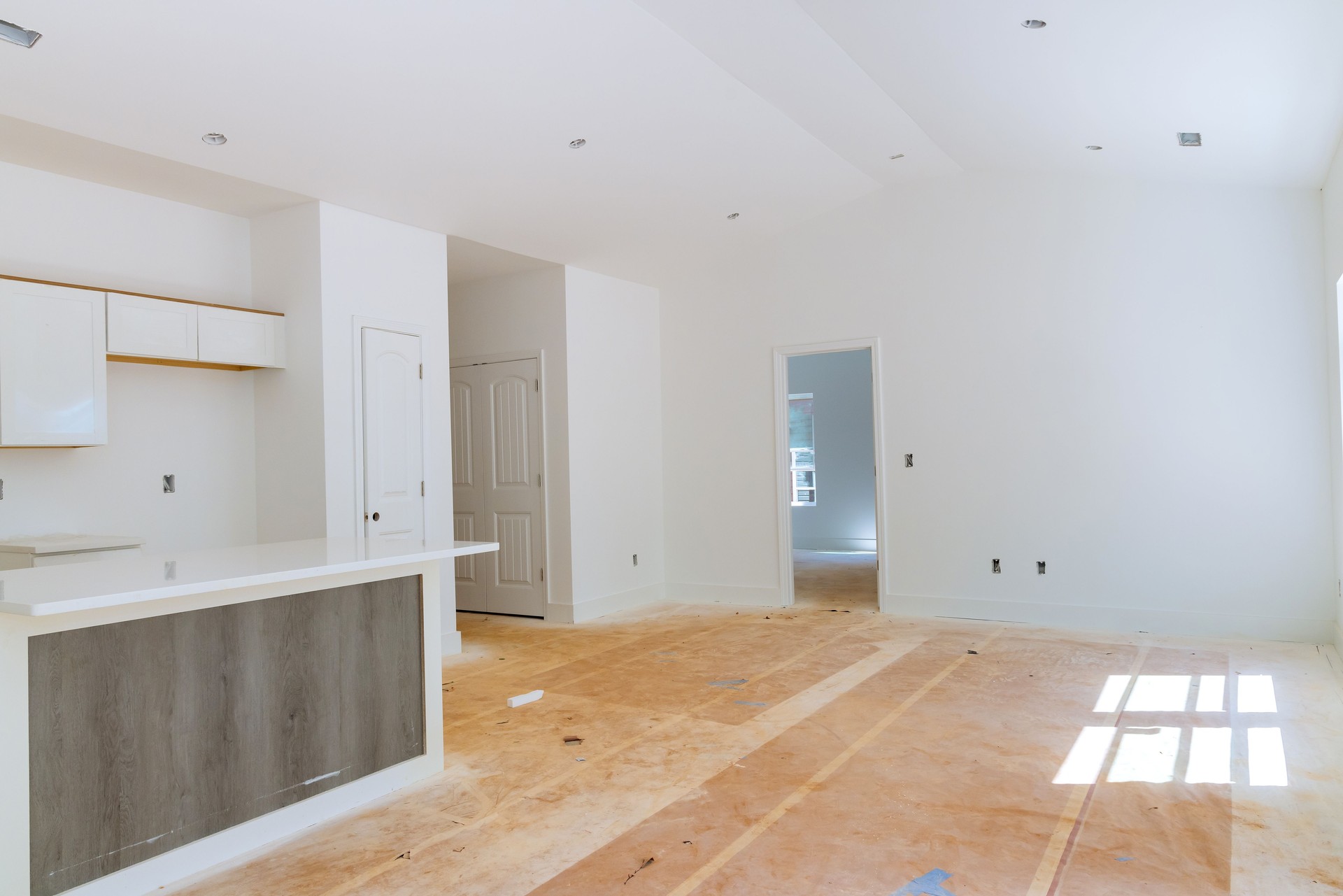 A white kitchen cabinet installation in a newly constructed house was carried out by a contractor